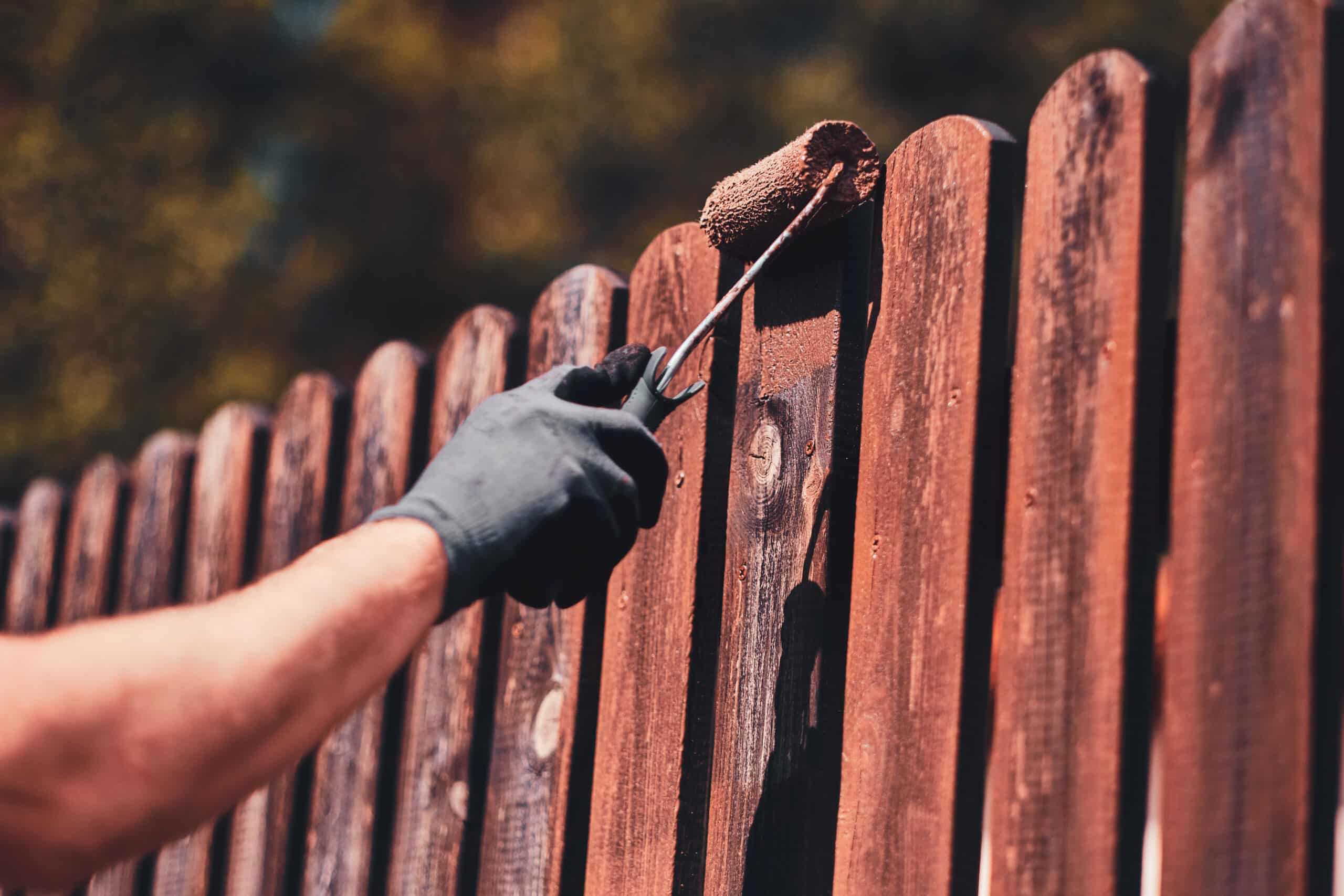 diligent man is painting fence with brush 2023 11 27 05 10 46 utc scaled